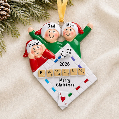 Personalized game night family of 3 christmas ornament laid on a soft white knit blanket