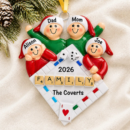 Personalized game night family of 4 christmas ornament laid on a soft white knit blanket