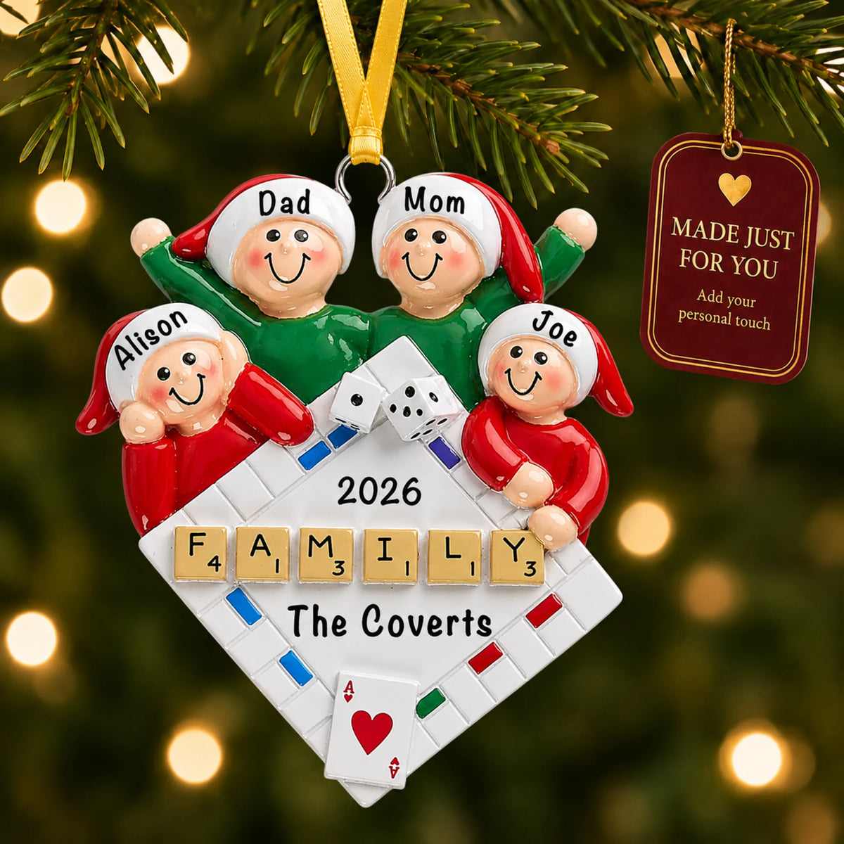 Game night family of 4 christmas ornament hanging on a lit Christmas tree with a Made Just For You gift tag