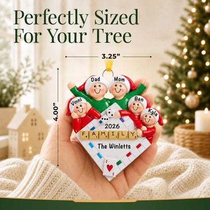 Size guide: the personalized game night family of 5 christmas ornament is 3.25 in wide by 4.00 in tall, shown in hand