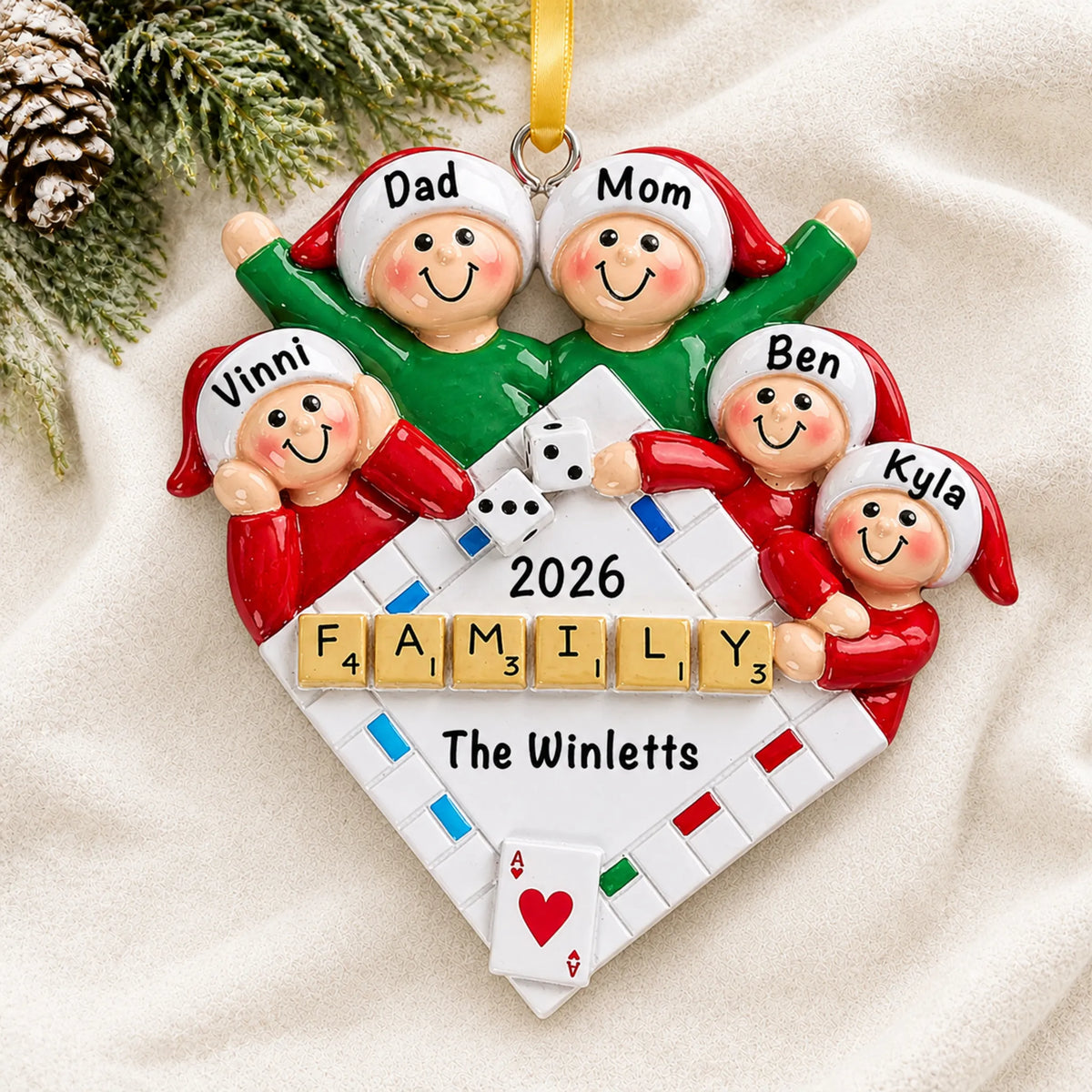 Personalized game night family of 5 christmas ornament laid on a soft white knit blanket