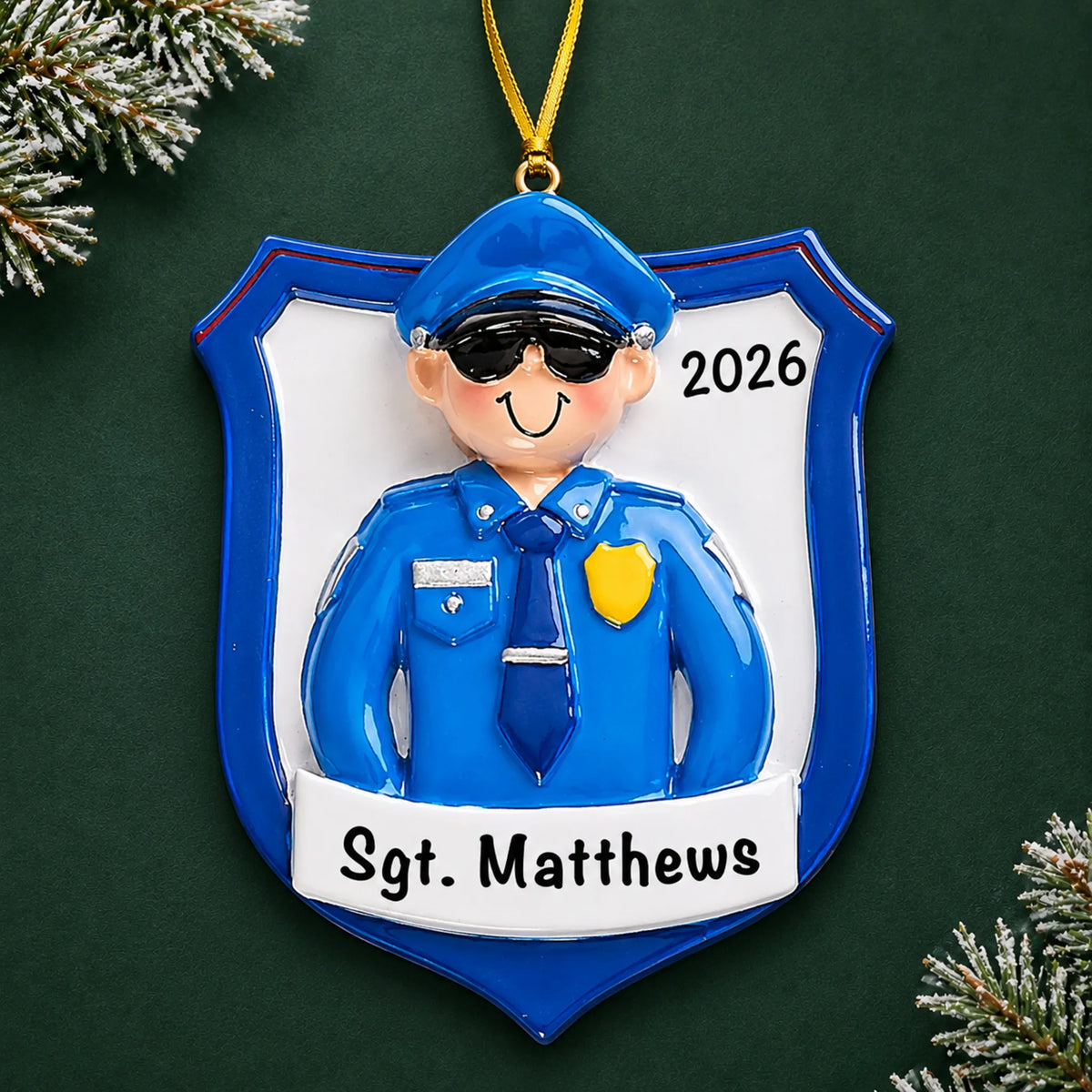 Personalized police officer guy christmas ornament on a dark green pine background