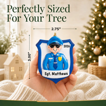 Size guide: the personalized police officer guy christmas ornament is 2.75 in wide by 3.00 in tall, shown in hand