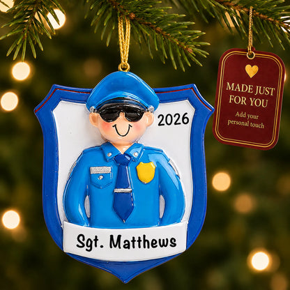 Police officer guy christmas ornament hanging on a lit Christmas tree with a Made Just For You gift tag