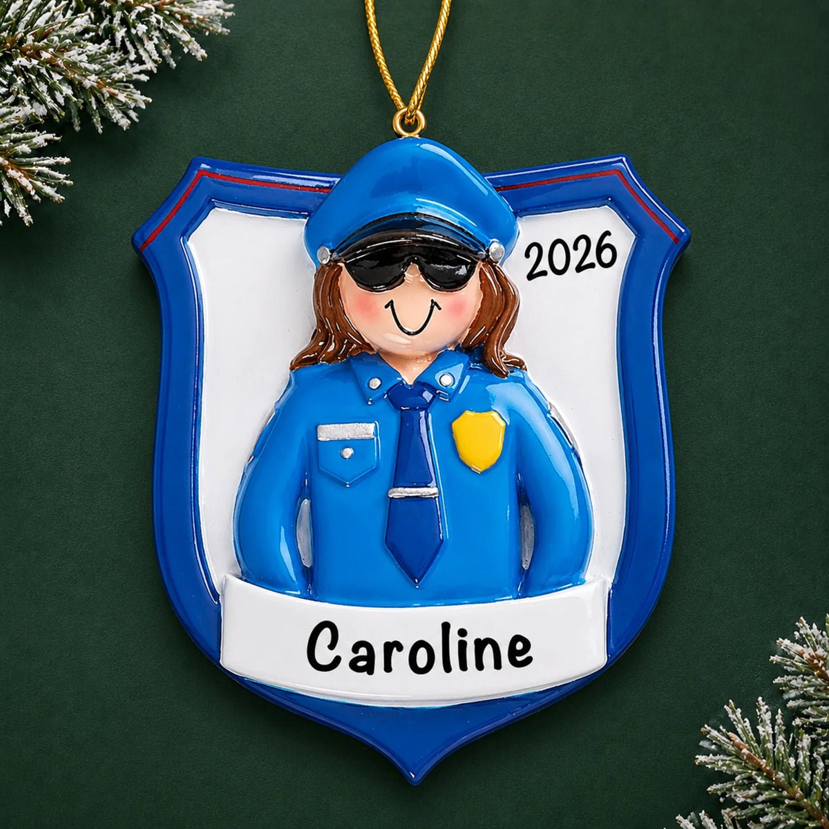 Personalized police officer woman christmas ornament on a dark green pine background
