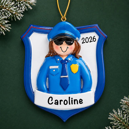 Personalized police officer woman christmas ornament on a dark green pine background