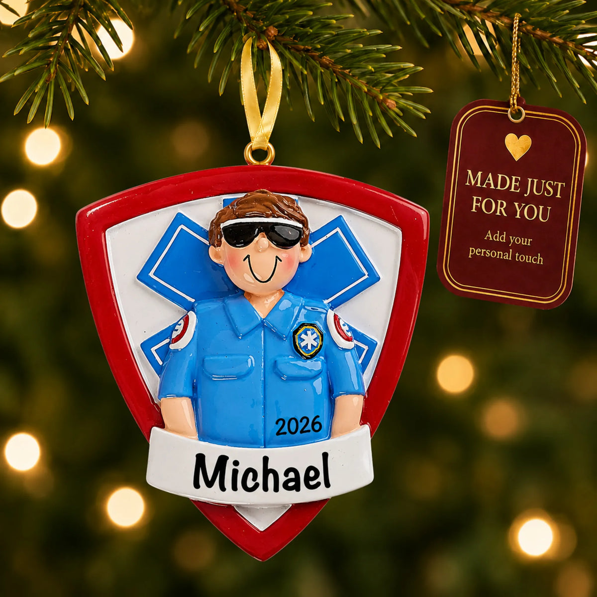 EMT paramedic christmas ornament hanging on a lit Christmas tree with a Made Just For You gift tag