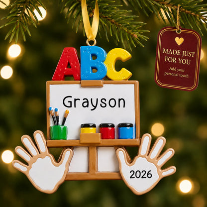 Personalized kindergarten ABC Christmas ornament hanging among tree lights with a Made Just For You tag