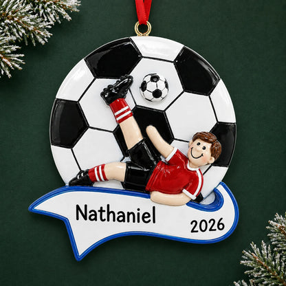 Personalized soccer kick boy christmas ornament on a dark green pine background