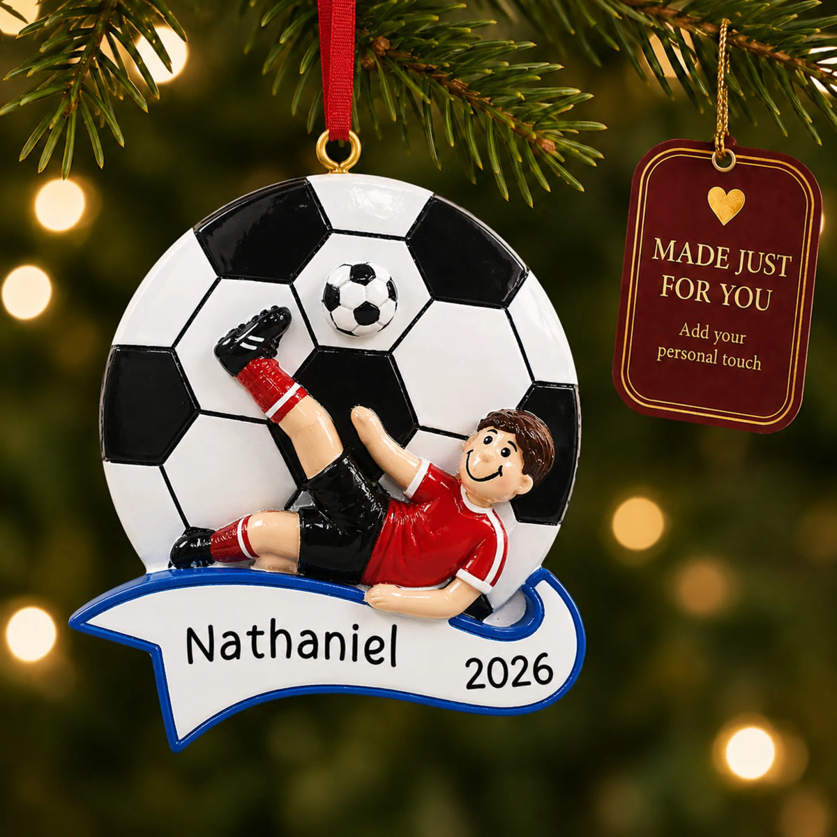 Soccer kick boy christmas ornament hanging on a lit Christmas tree with a Made Just For You gift tag