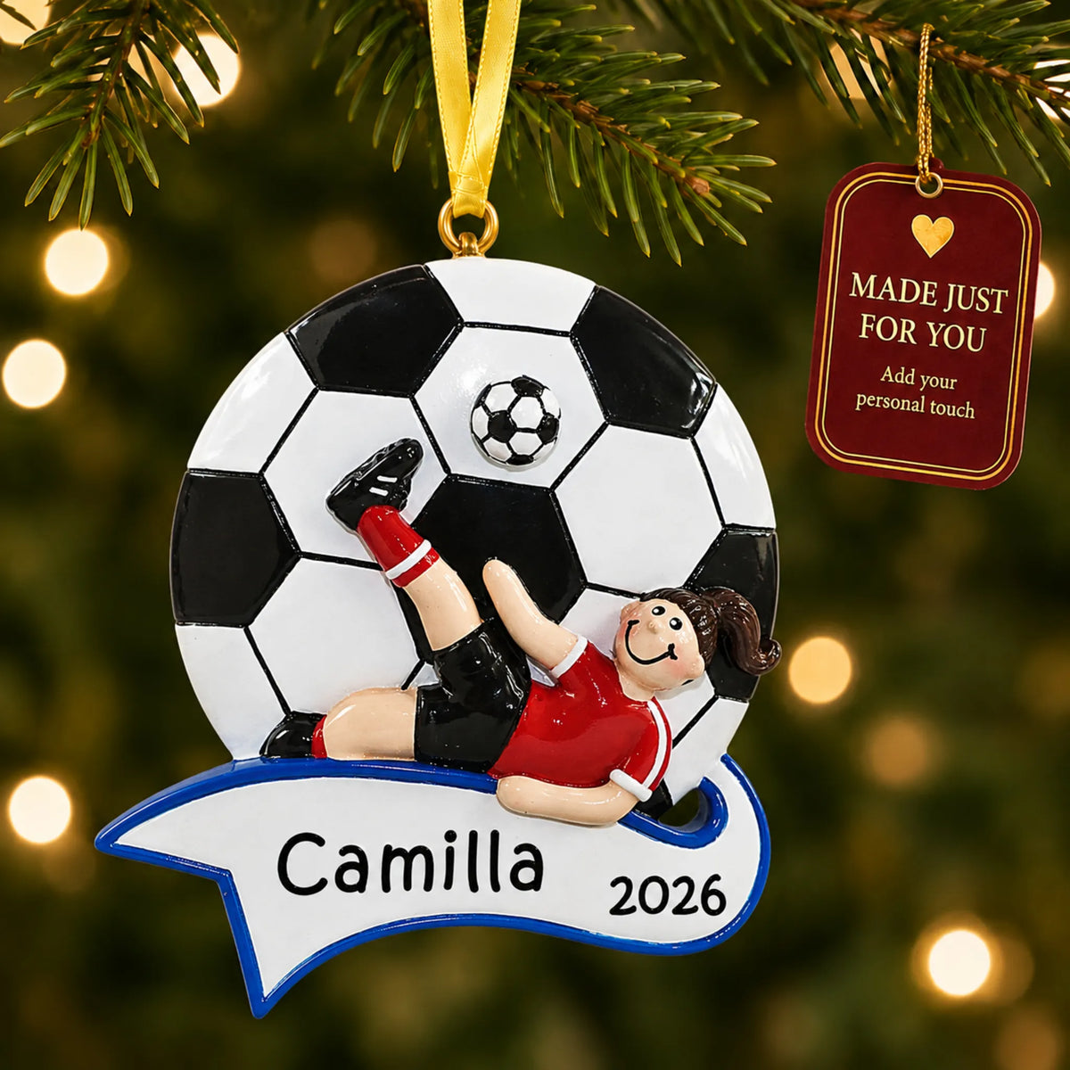 Soccer kick girl christmas ornament hanging on a lit Christmas tree with a Made Just For You gift tag