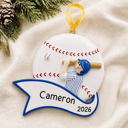 Personalized baseball boy swing christmas ornament laid on a soft white knit blanket