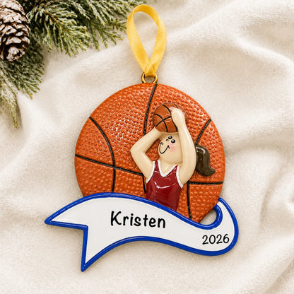 Personalized basketball shot girl christmas ornament laid on a soft white knit blanket