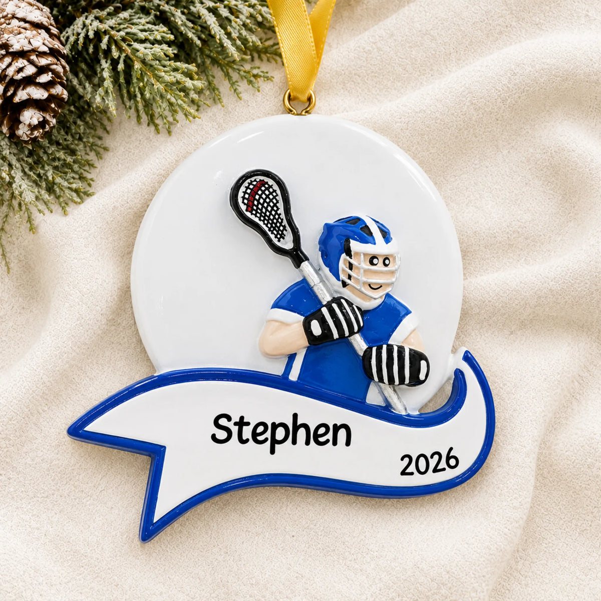 Personalized lacrosse shot boy christmas ornament laid on a soft white knit blanket