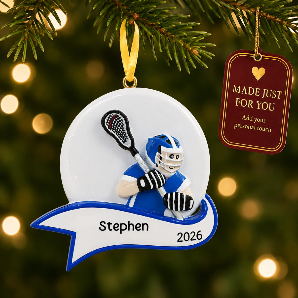 Lacrosse shot boy christmas ornament hanging on a lit Christmas tree with a Made Just For You gift tag