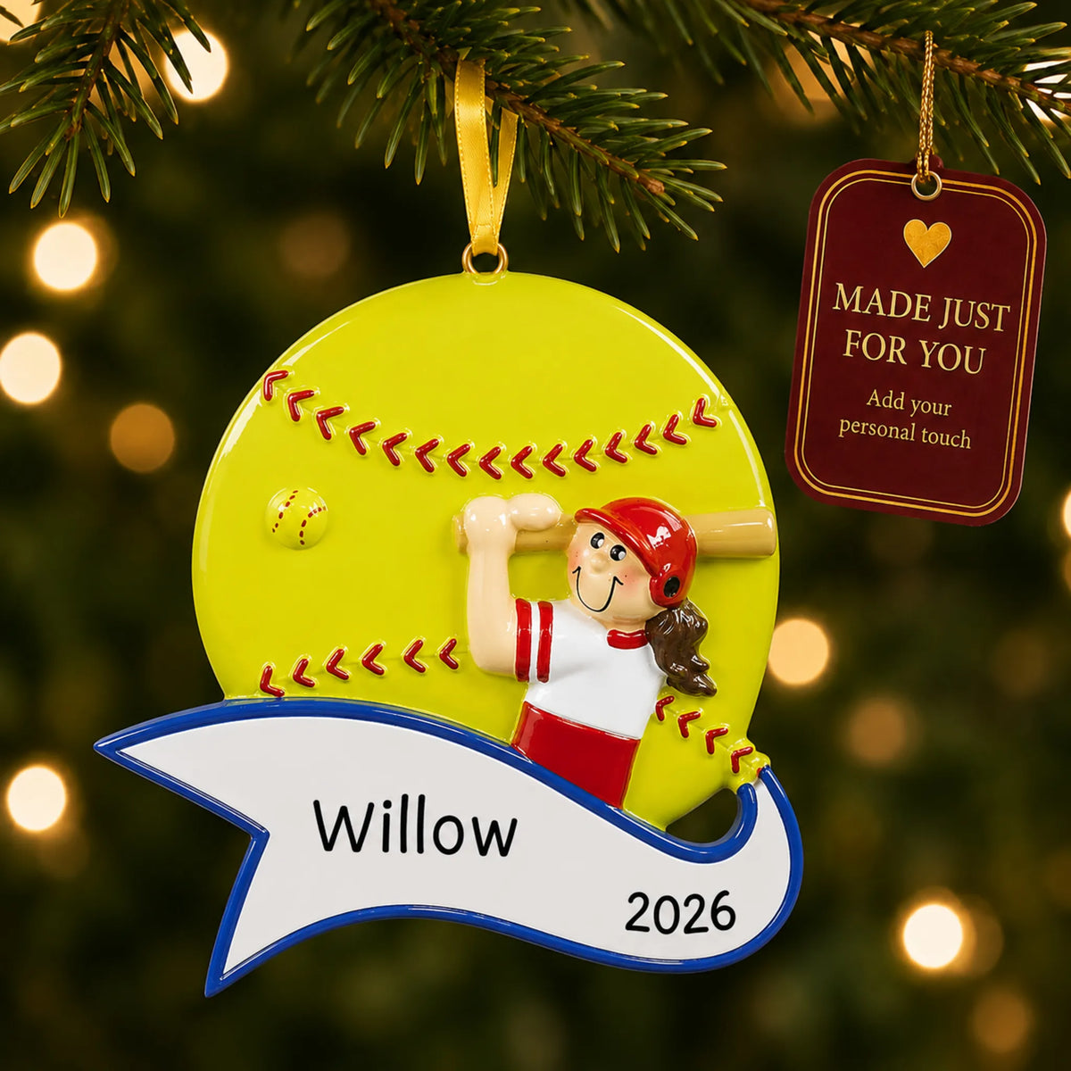 Softball batter girl christmas ornament hanging on a lit Christmas tree with a Made Just For You gift tag