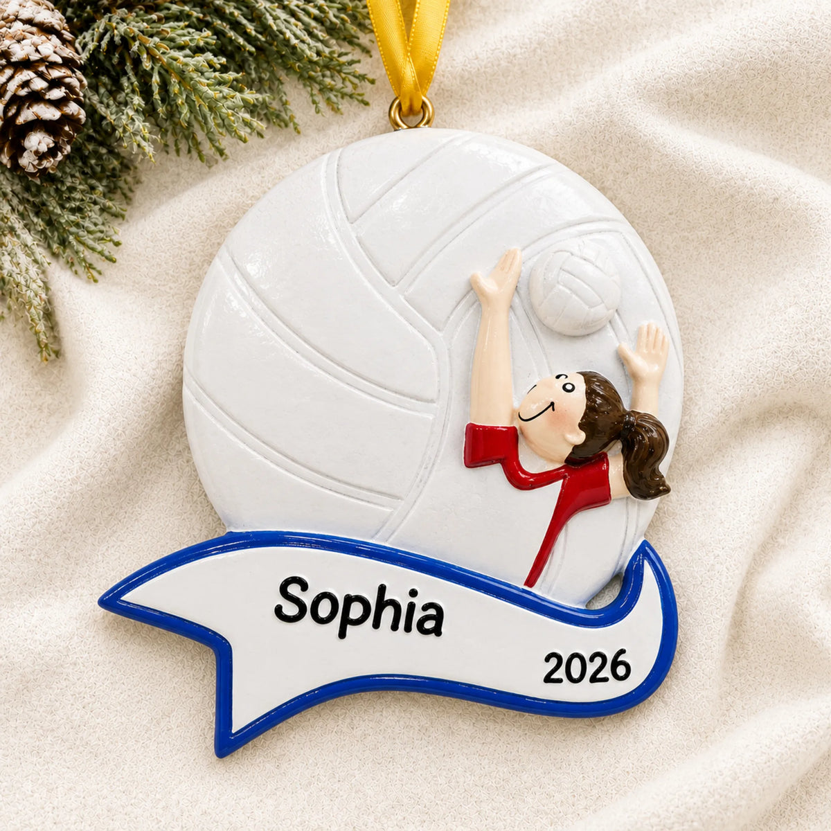 Personalized volleyball serve girl christmas ornament laid on a soft white knit blanket