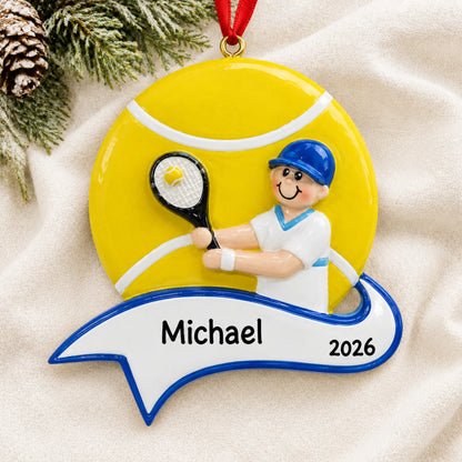 Personalized tennis boy christmas ornament laid on a soft white knit blanket