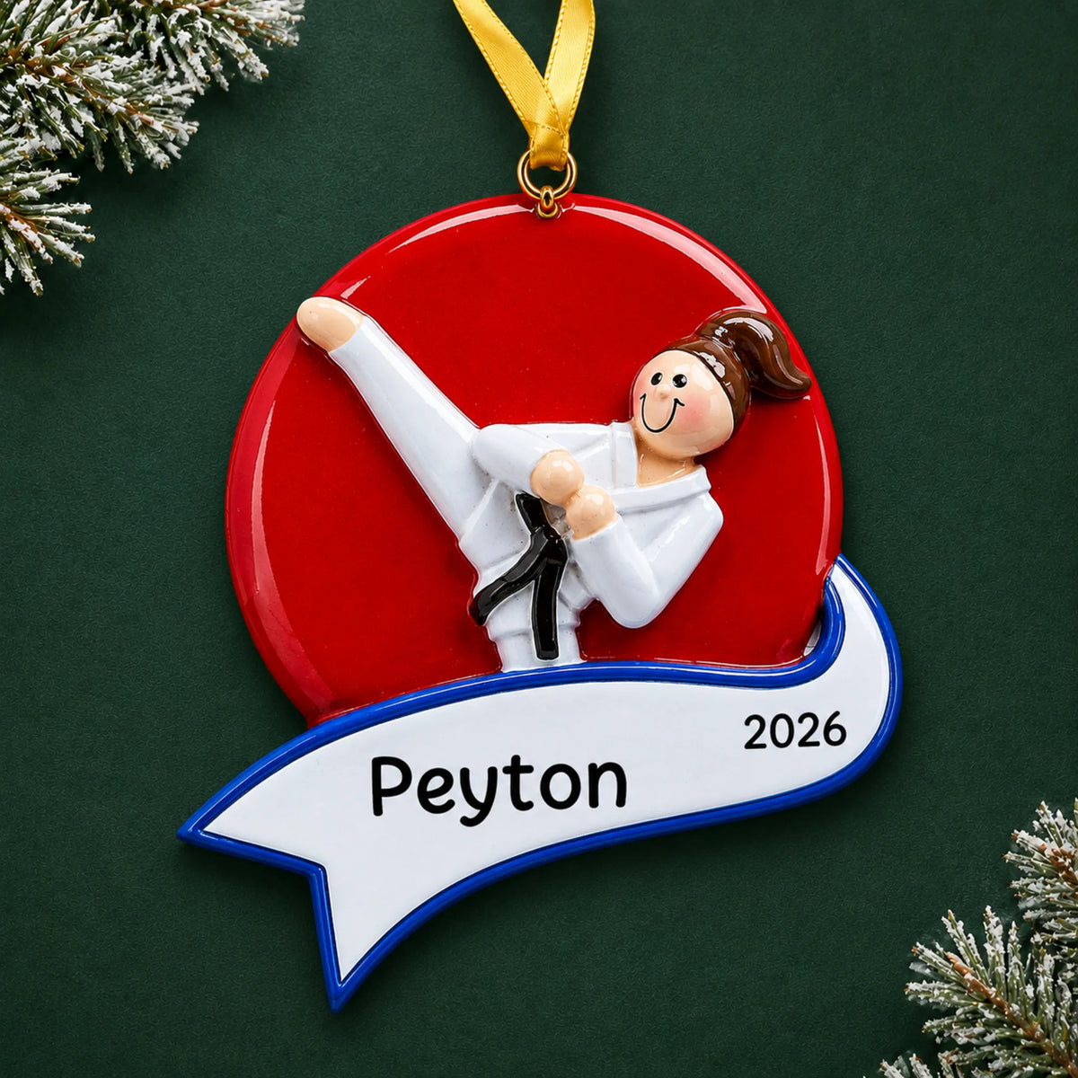 Personalized karate kick girl christmas ornament on a dark green pine background