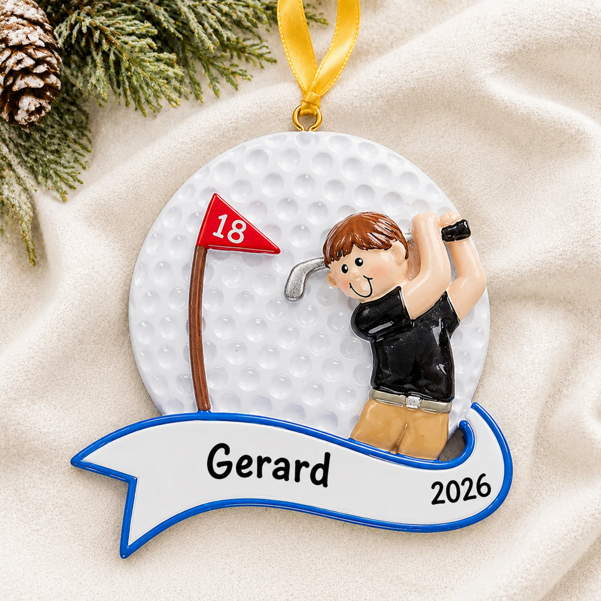 Personalized golfer swing guy christmas ornament laid on a soft white knit blanket