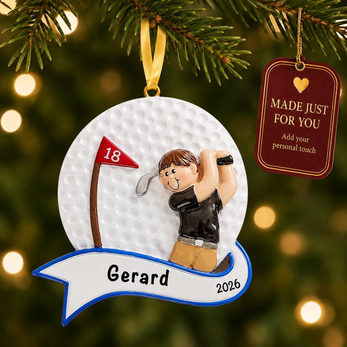 Golfer swing guy christmas ornament hanging on a lit Christmas tree with a Made Just For You gift tag