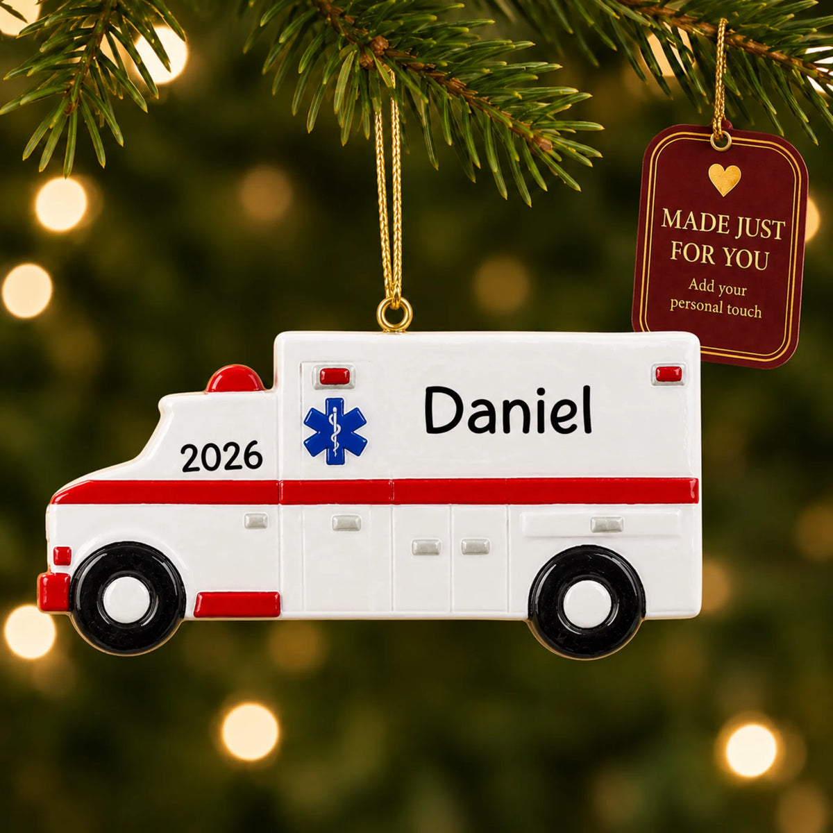 Ambulance christmas ornament hanging on a lit Christmas tree with a Made Just For You gift tag