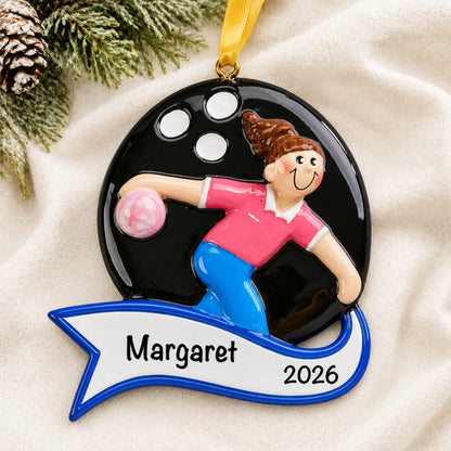 Personalized bowling girl christmas ornament laid on a soft white knit blanket