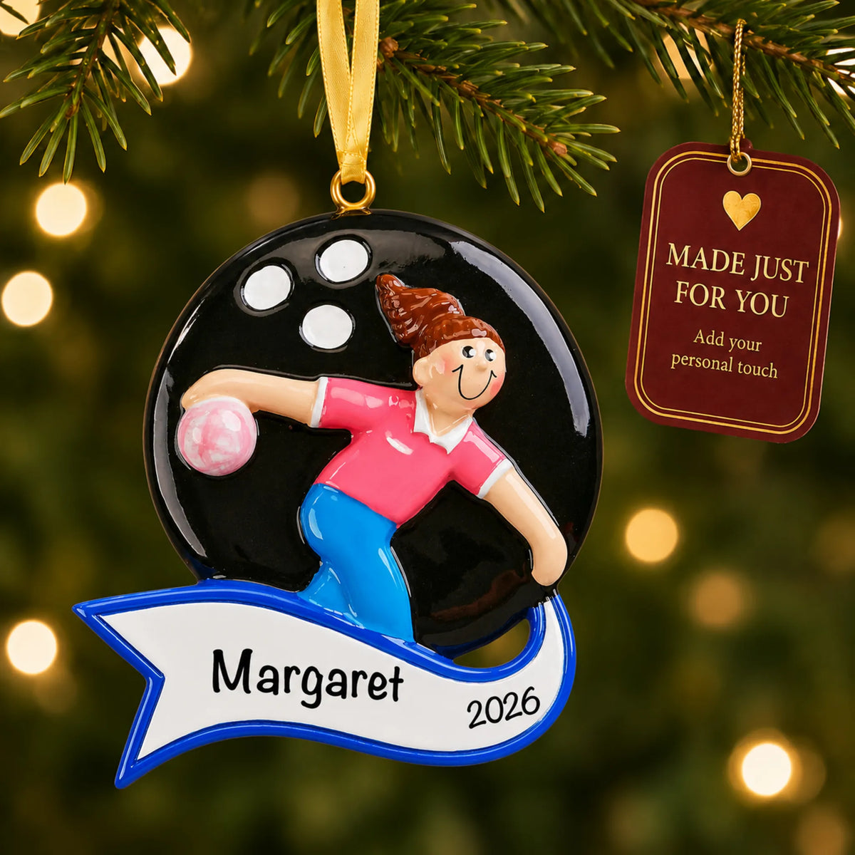 Bowling girl christmas ornament hanging on a lit Christmas tree with a Made Just For You gift tag