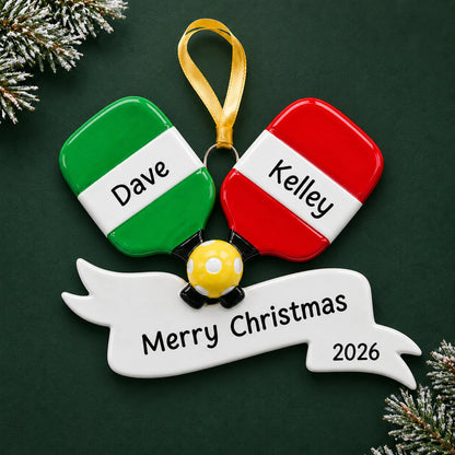 Personalized pickleball paddles christmas ornament on a dark green pine background