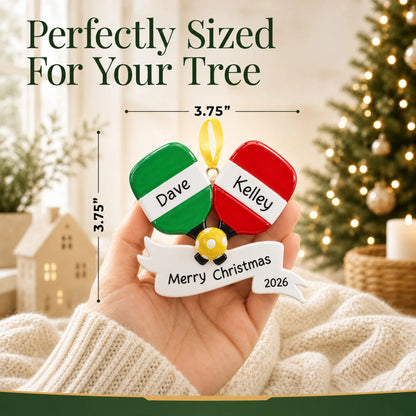 Size guide: the personalized pickleball paddles christmas ornament shown in hand next to a Christmas tree