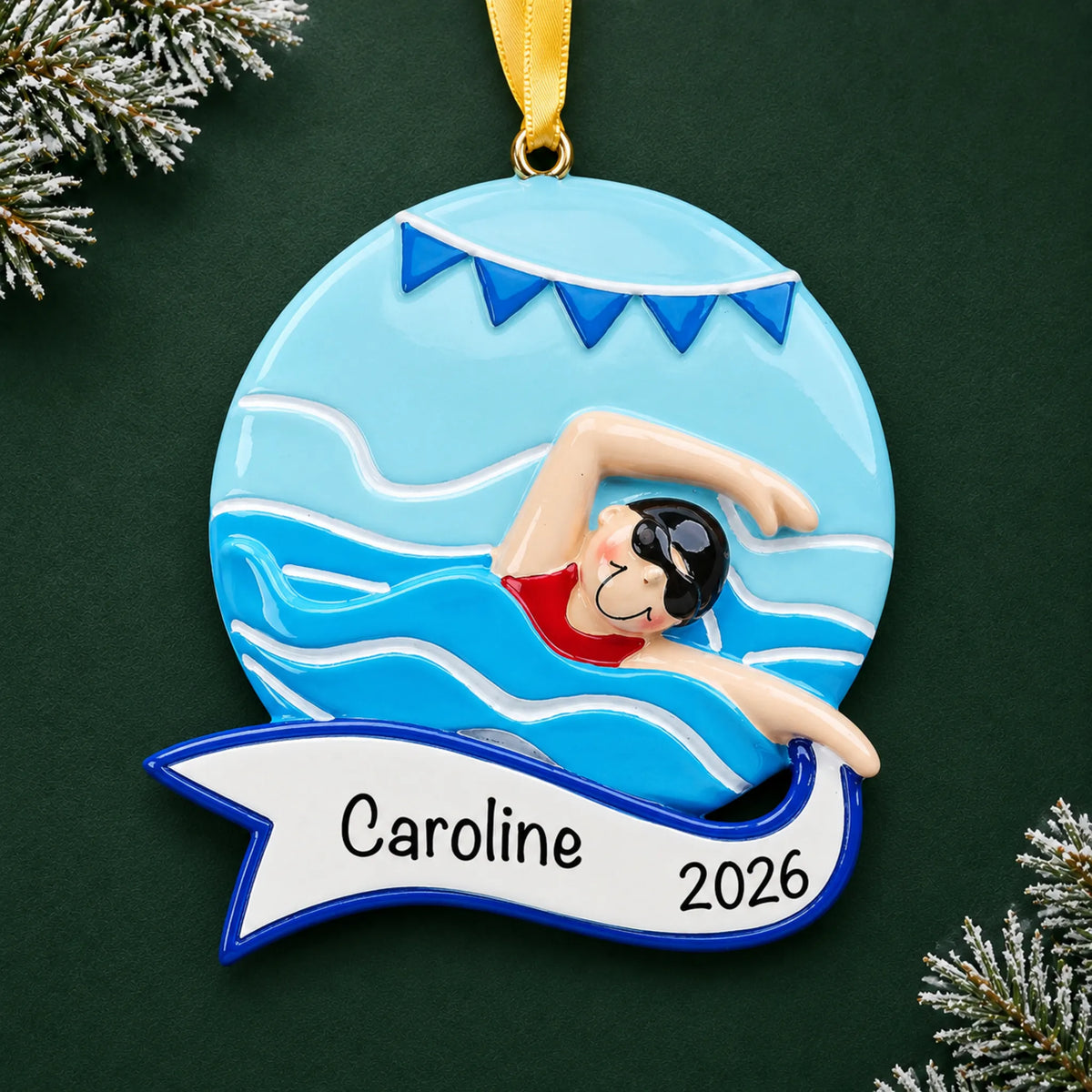 Personalized girl swimming mid-stroke christmas ornament on a dark green pine background