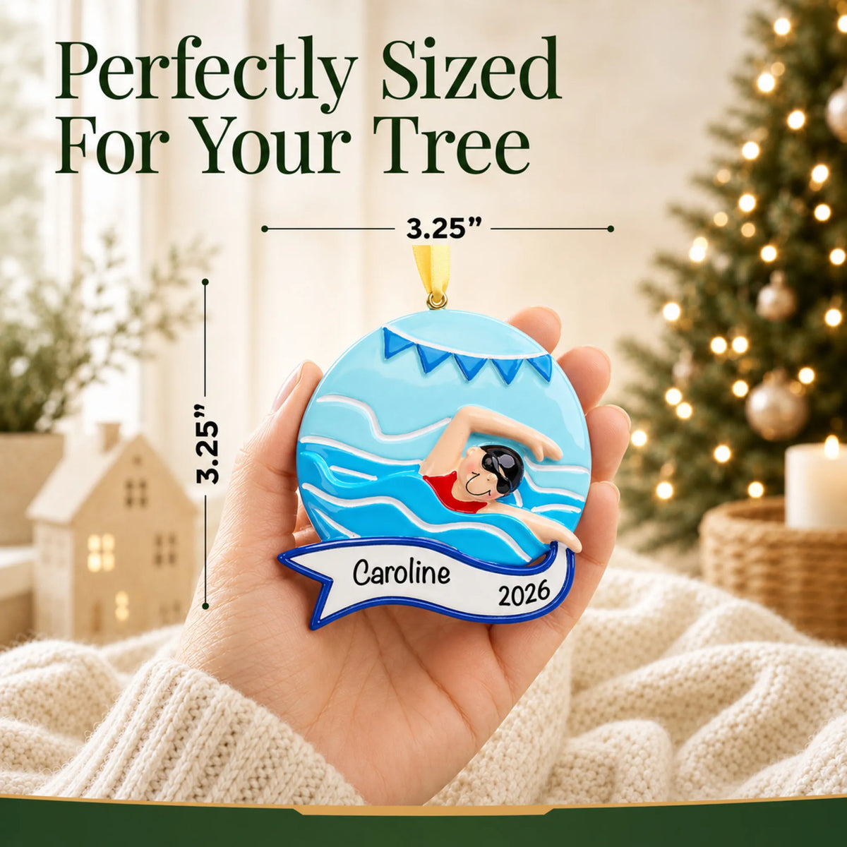 Size guide: the personalized girl swimming mid-stroke christmas ornament shown in hand next to a Christmas tree