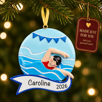 Girl swimming mid-stroke christmas ornament hanging on a lit Christmas tree with a Made Just For You gift tag