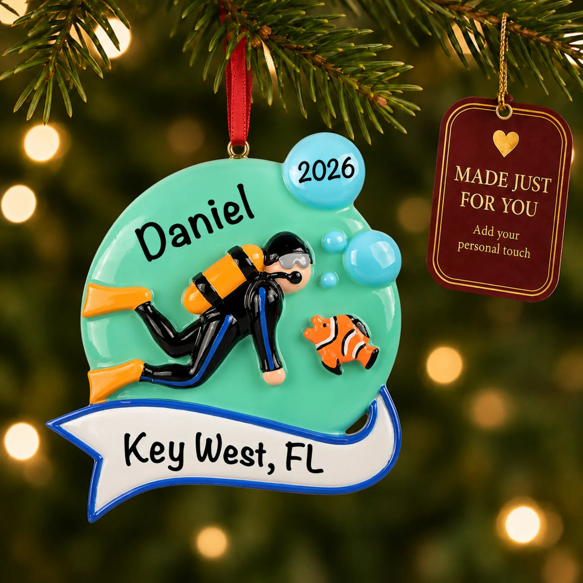 Scuba diver christmas ornament hanging on a lit Christmas tree with a Made Just For You gift tag