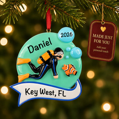 Scuba diver christmas ornament hanging on a lit Christmas tree with a Made Just For You gift tag