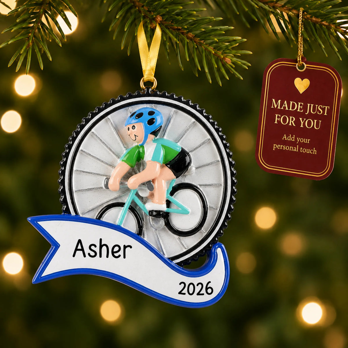 Cycling boy christmas ornament hanging on a lit Christmas tree with a Made Just For You gift tag