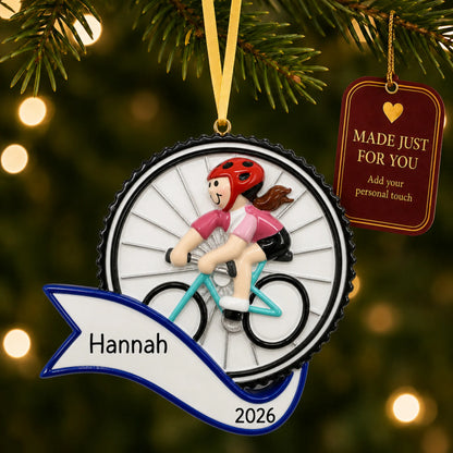 Cycling girl christmas ornament hanging on a lit Christmas tree with a Made Just For You gift tag