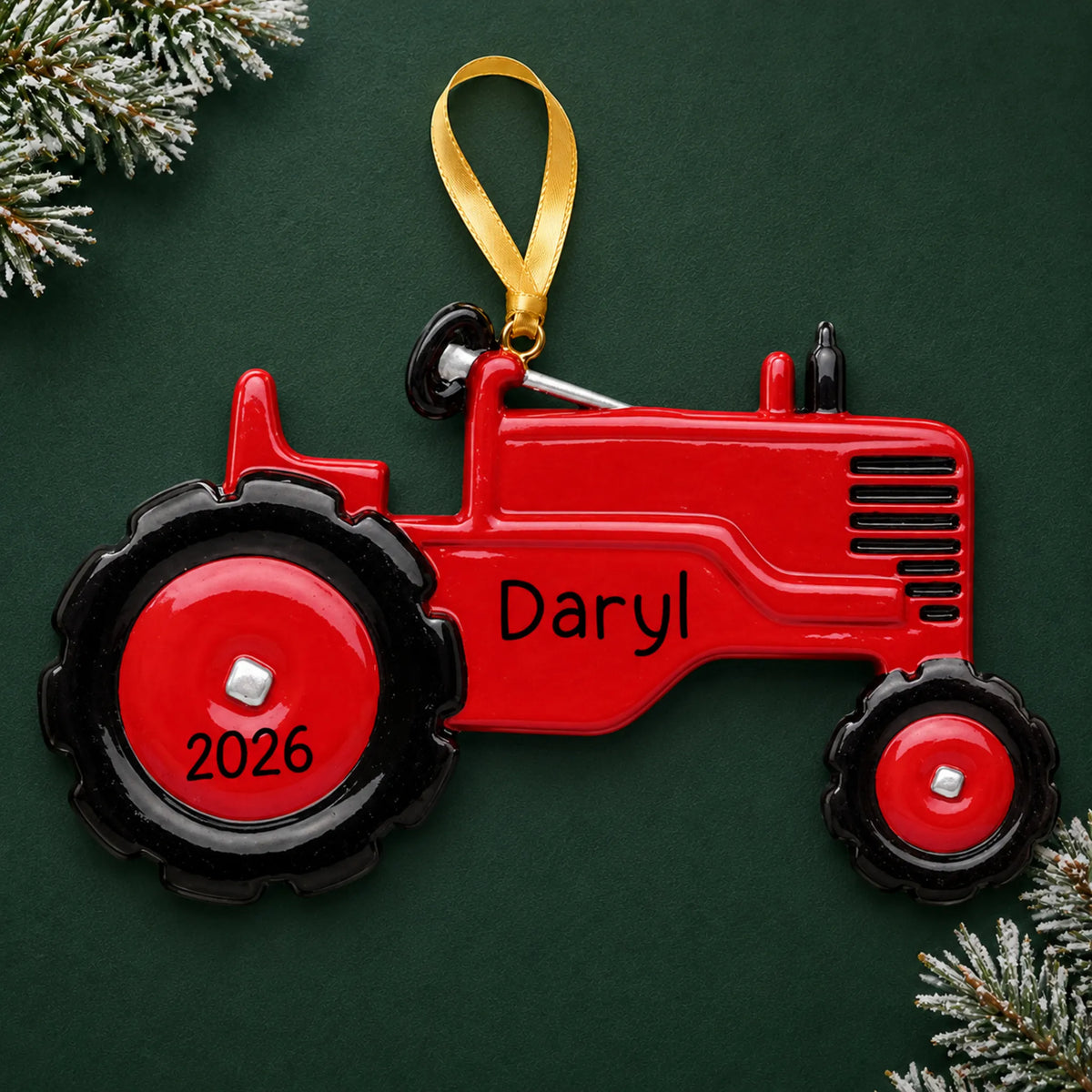 Personalized red tractor christmas ornament on a dark green pine background