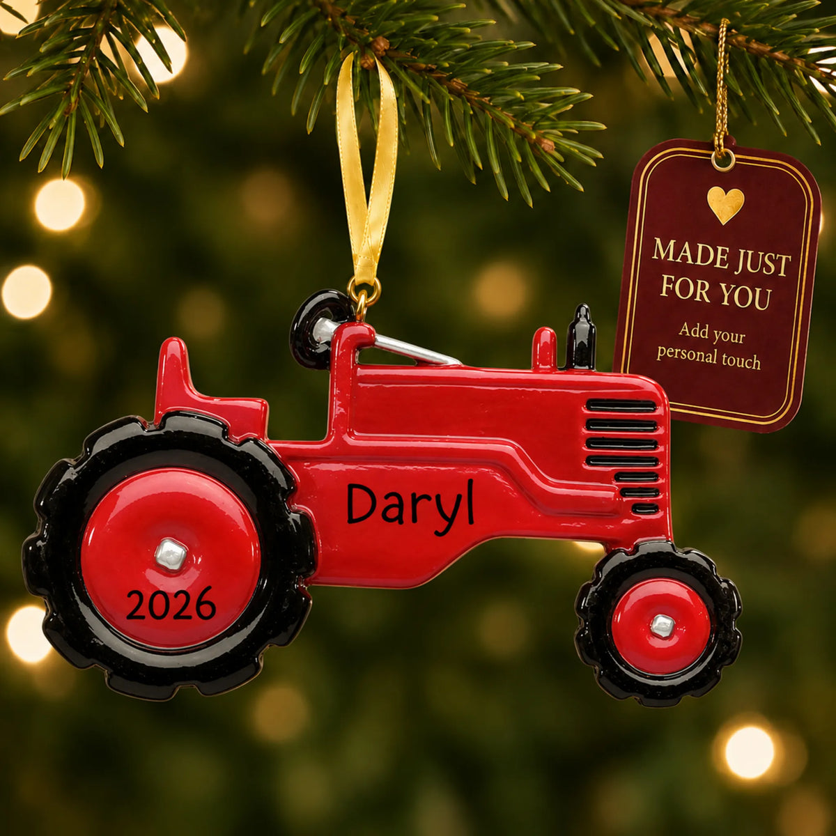 Red tractor christmas ornament hanging on a lit Christmas tree with a Made Just For You gift tag