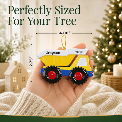 Size guide: the personalized yellow kids dump truck christmas ornament is 4.00 in wide by 2.75 in tall, shown in hand