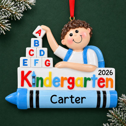 Personalized kindergarten boy Christmas ornament with name and year, shown on a green holiday background