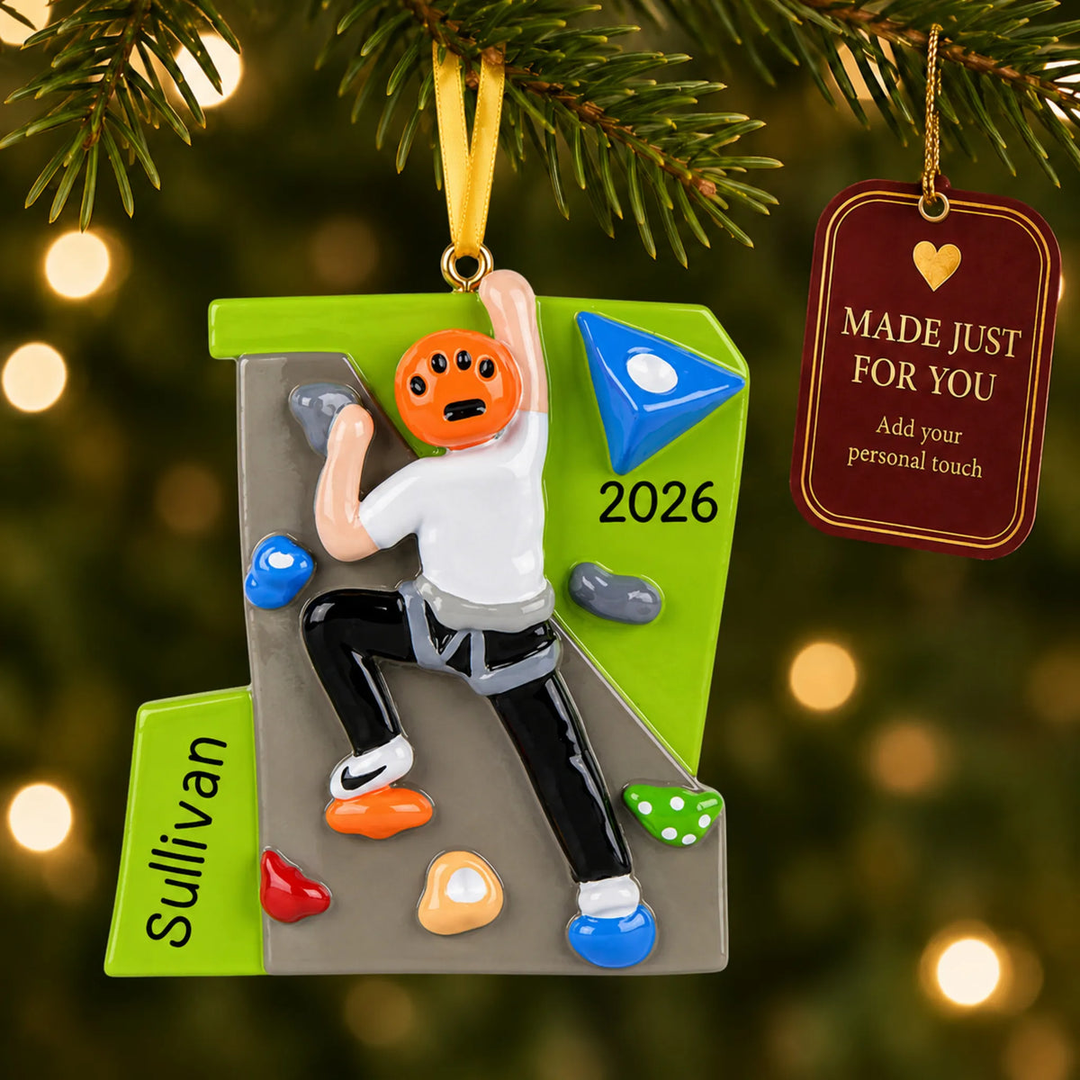 Rock climber guy christmas ornament hanging on a lit Christmas tree with a Made Just For You gift tag