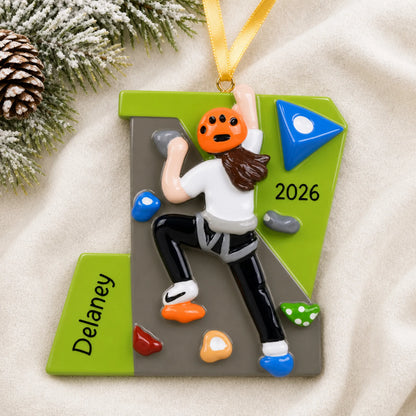 Personalized girl rock climber christmas ornament laid on a soft white knit blanket