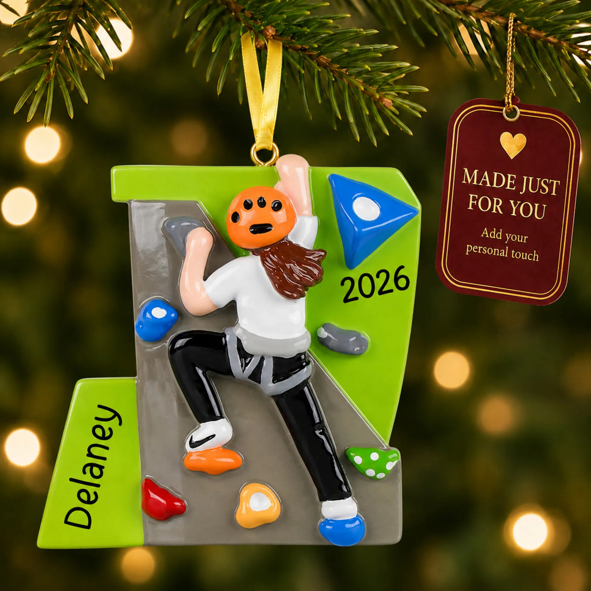 Girl rock climber christmas ornament hanging on a lit Christmas tree with a Made Just For You gift tag