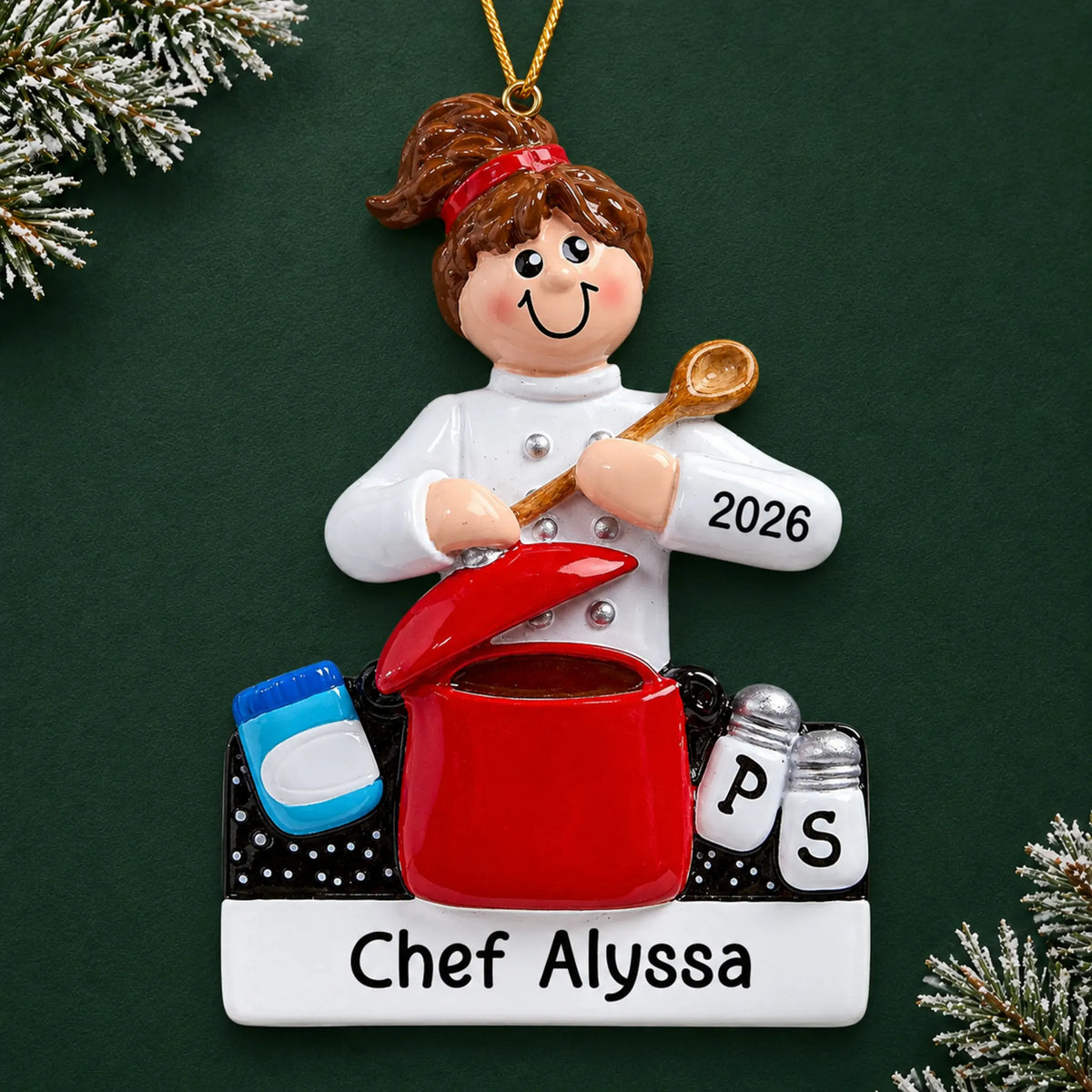 Personalized chef christmas ornament on a dark green pine background