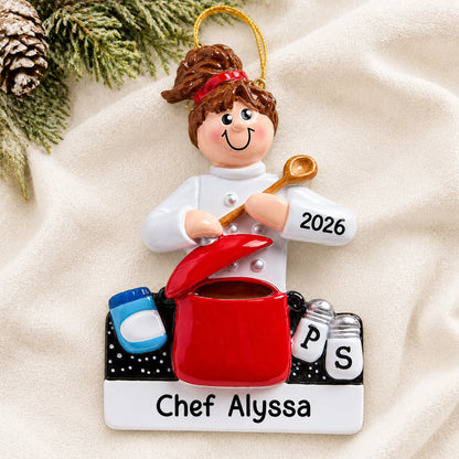 Personalized chef christmas ornament laid on a soft white knit blanket