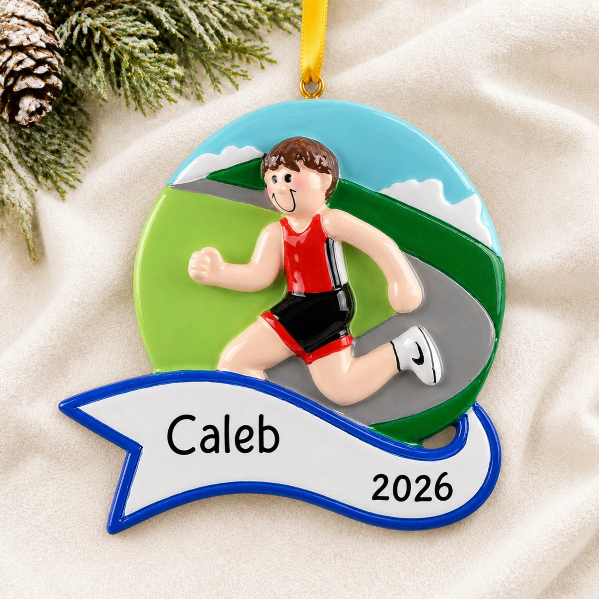Personalized jogger boy christmas ornament laid on a soft white knit blanket