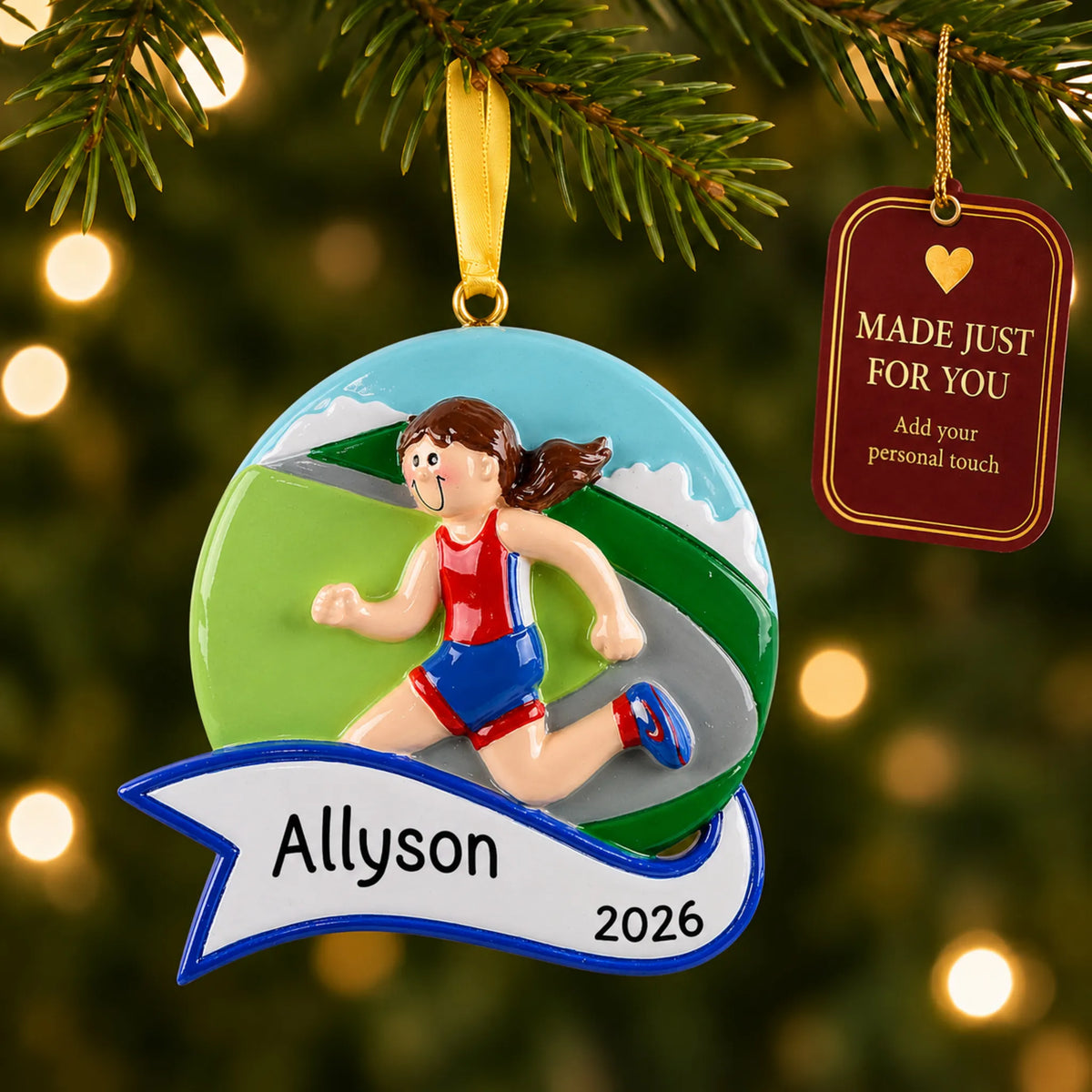 Jogger girl christmas ornament hanging on a lit Christmas tree with a Made Just For You gift tag