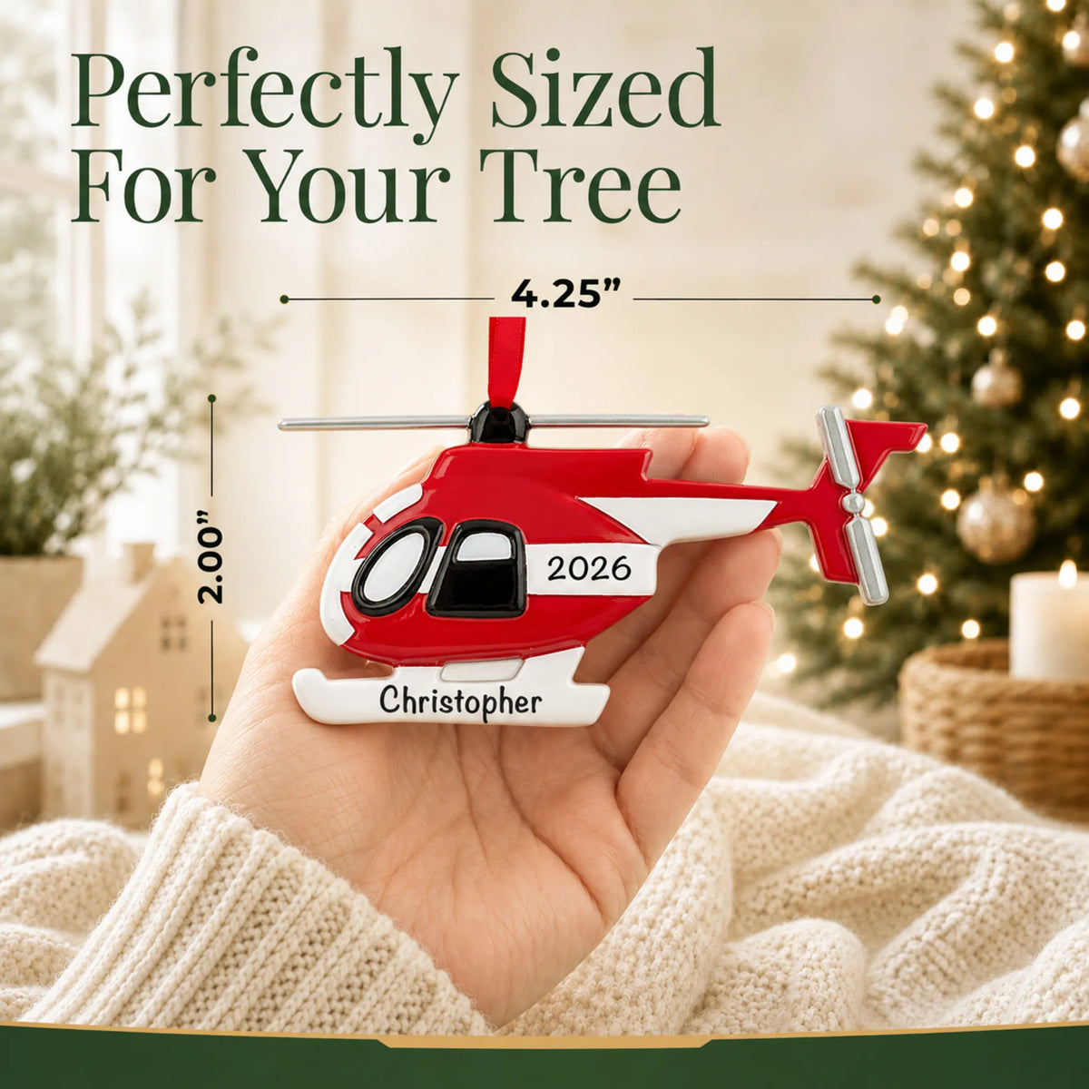 Size guide: the personalized helicopter christmas ornament is 4.25 in wide by 2.00 in tall, shown in hand