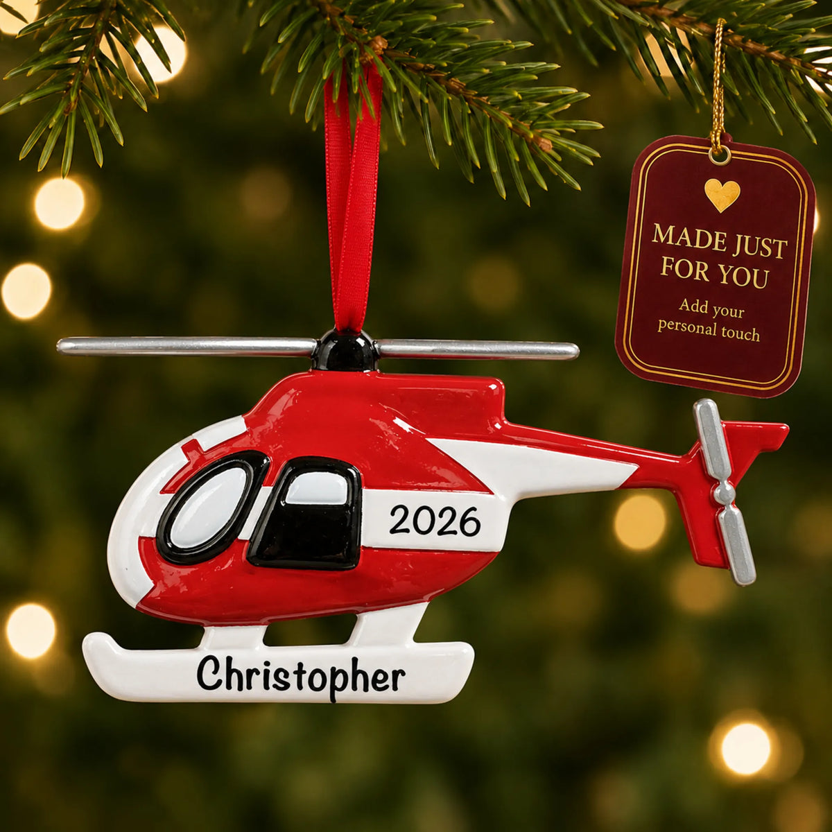 Helicopter christmas ornament hanging on a lit Christmas tree with a Made Just For You gift tag